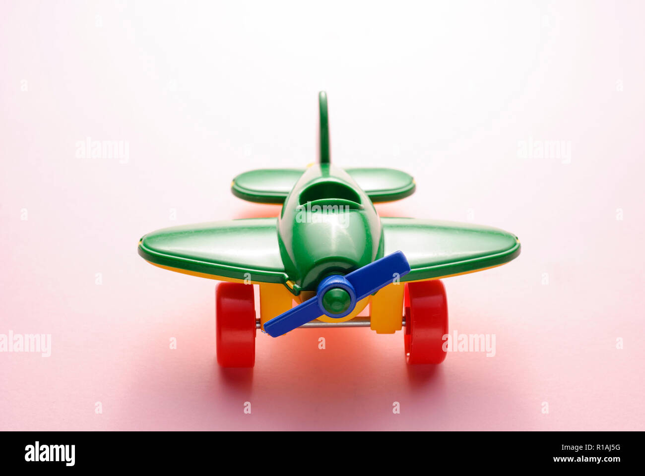 Children's toy green plane on a pink gradient background Stock Photo ...
