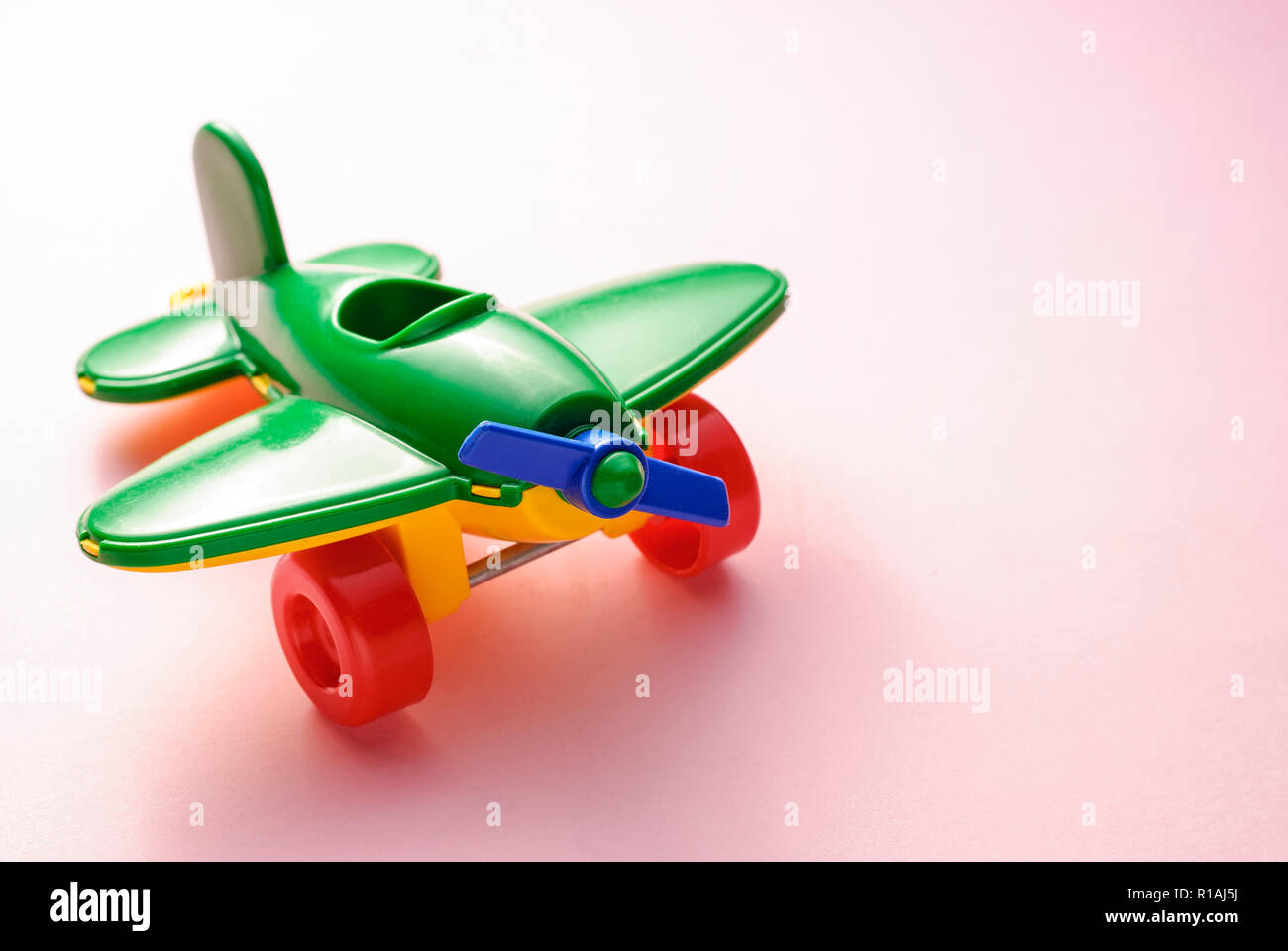 Children's toy green plane on a pink gradient background Stock Photo ...