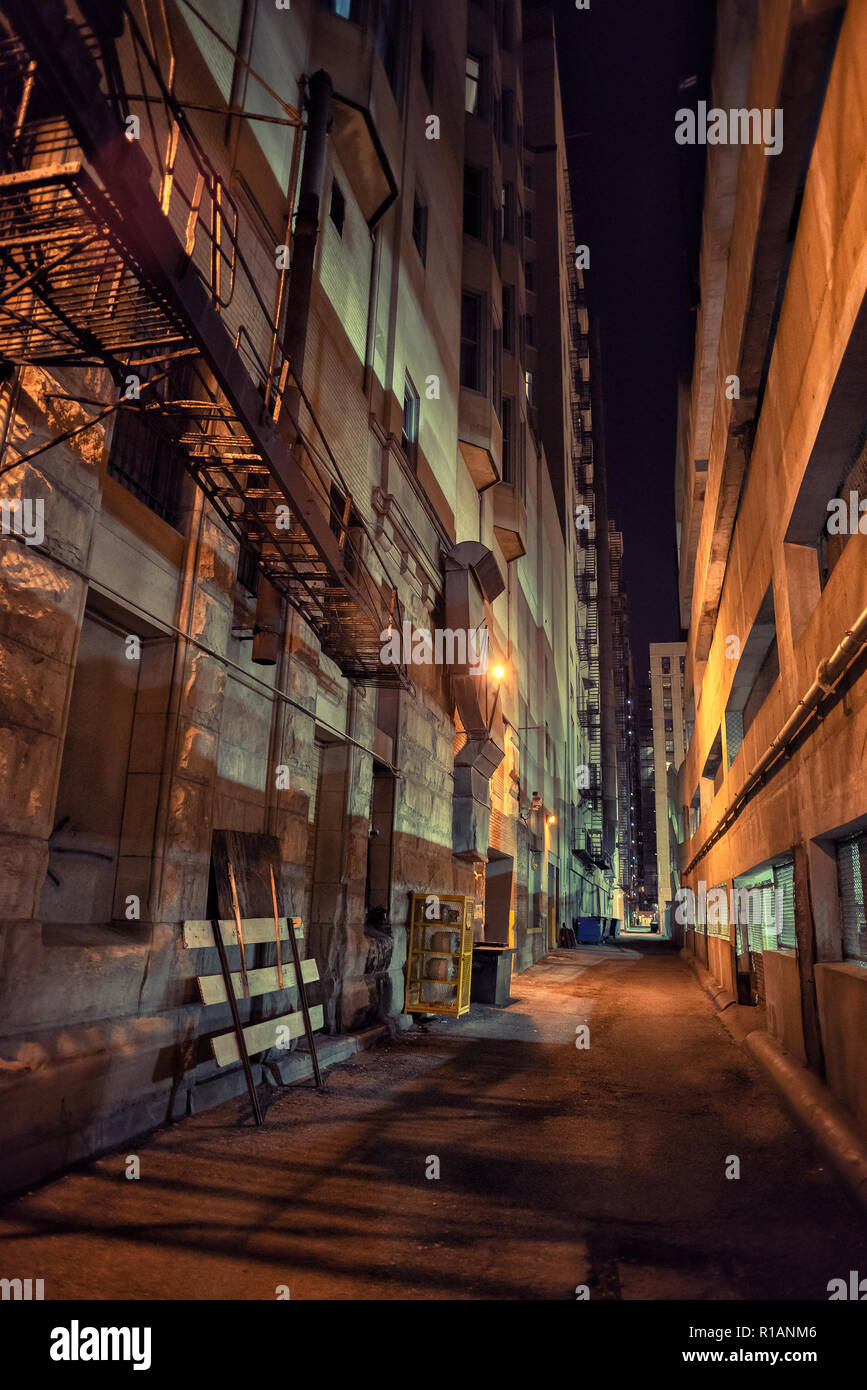 Dark And Eerie Downtown Urban City Alley With A Fire Escape Next At Night Stock Photo Alamy