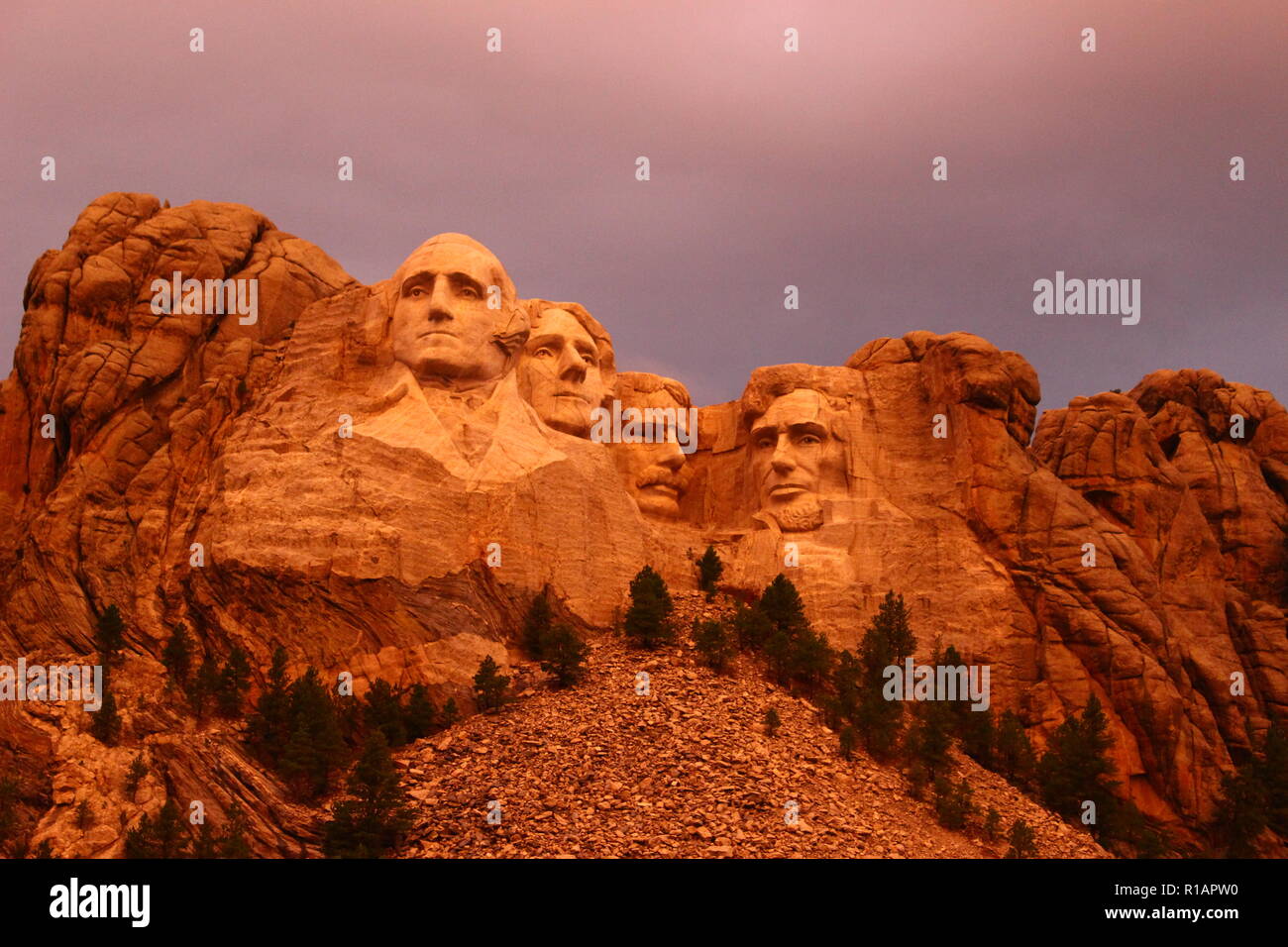 Mount Rushmore in the South Dakota Black Hills National Forest. Summertime with the warm glow of an early evening sun shining on the president's faces Stock Photo