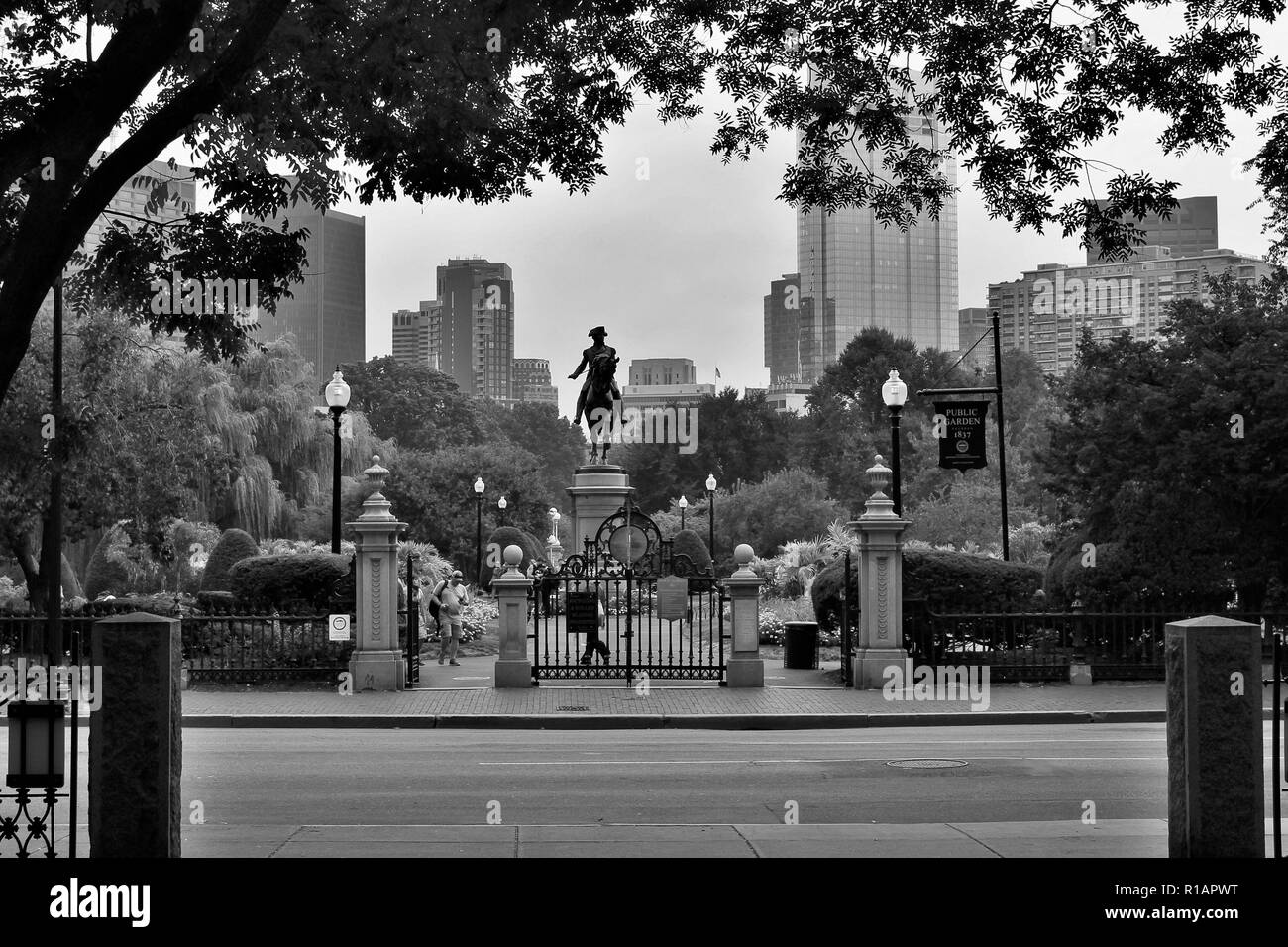 Black and white photo of the Public Garden in Boston, MA with George Washington statue.  Taken from across Arlington street Stock Photo