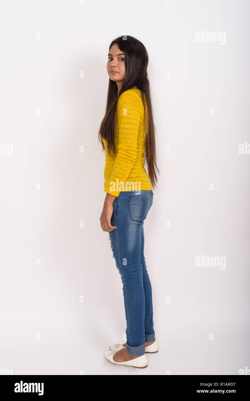 Full body shot of young Indian woman standing while looking at c Stock Photo