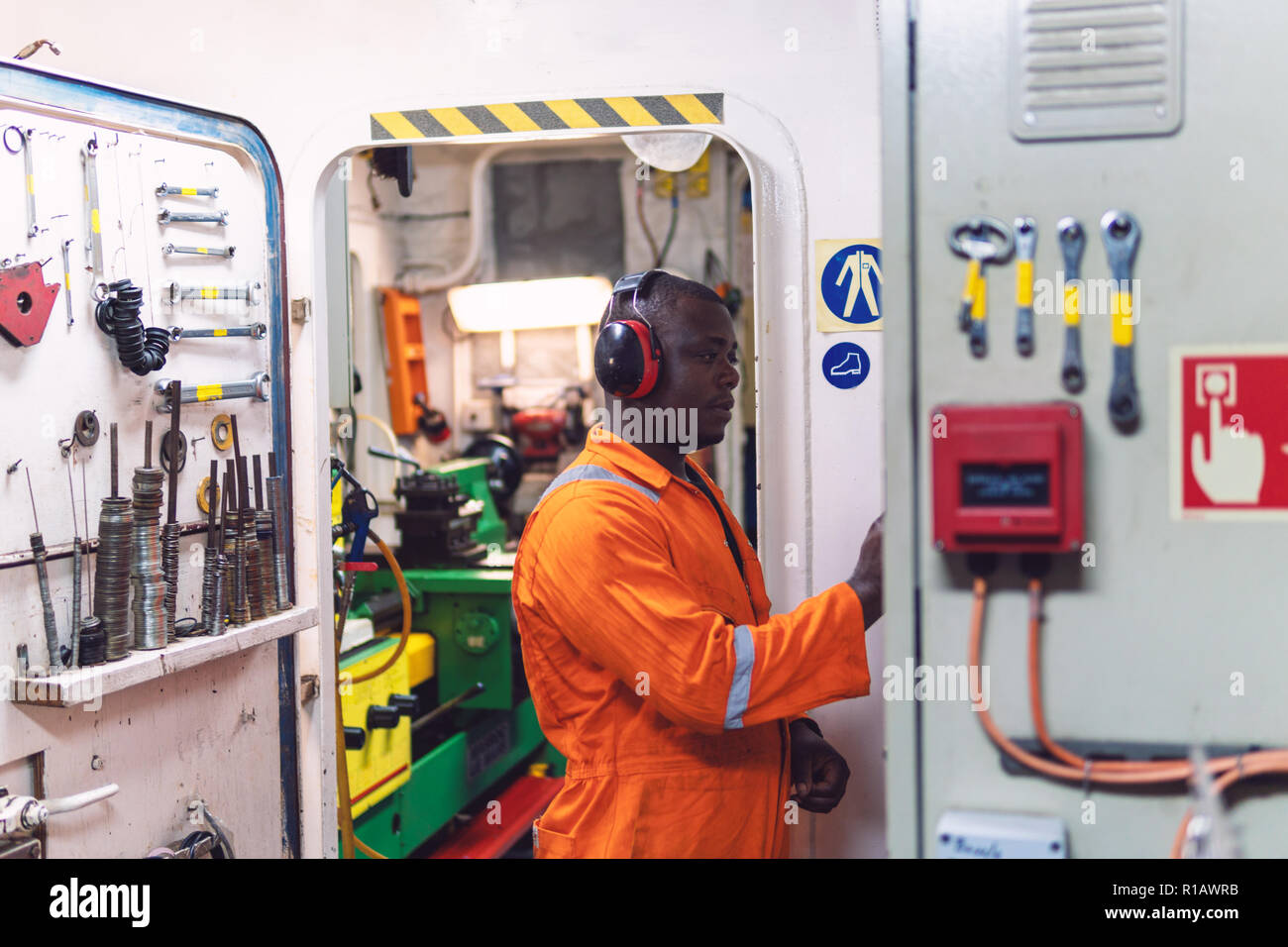 Marine engineer officer working in engine room Stock Photo Alamy