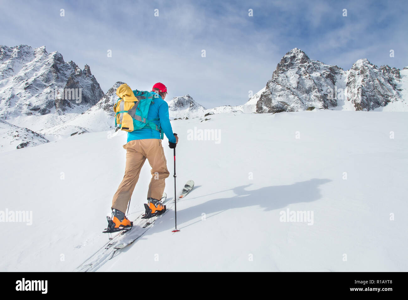 A skier walks in the mountains Stock Photo