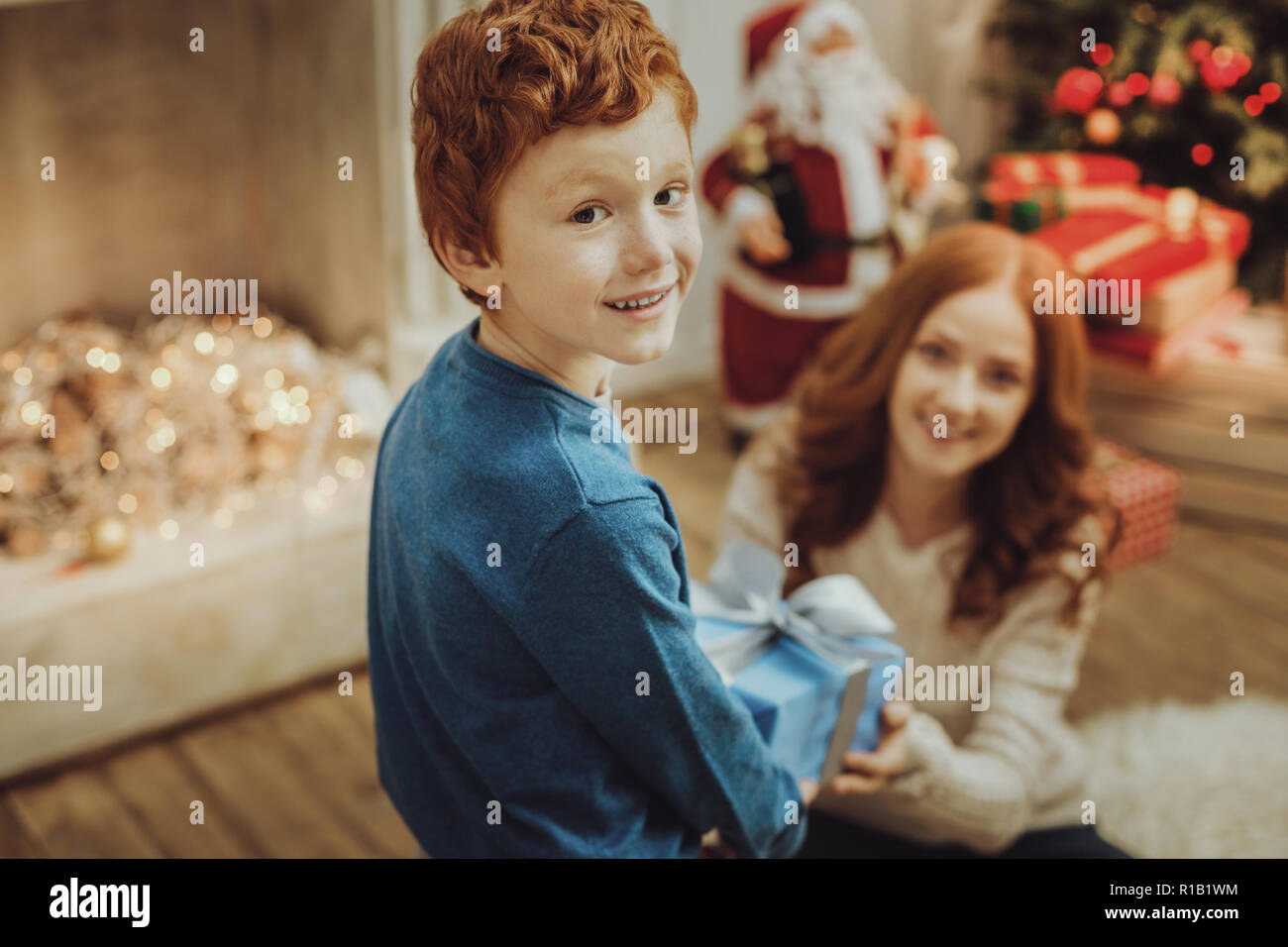 Handsome boy celebrating Christmas with his mommy Stock Photo