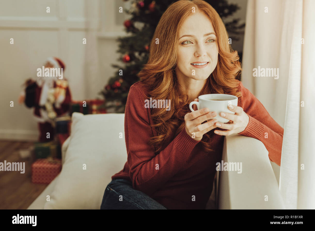 Dreamy young woman creating plans Stock Photo