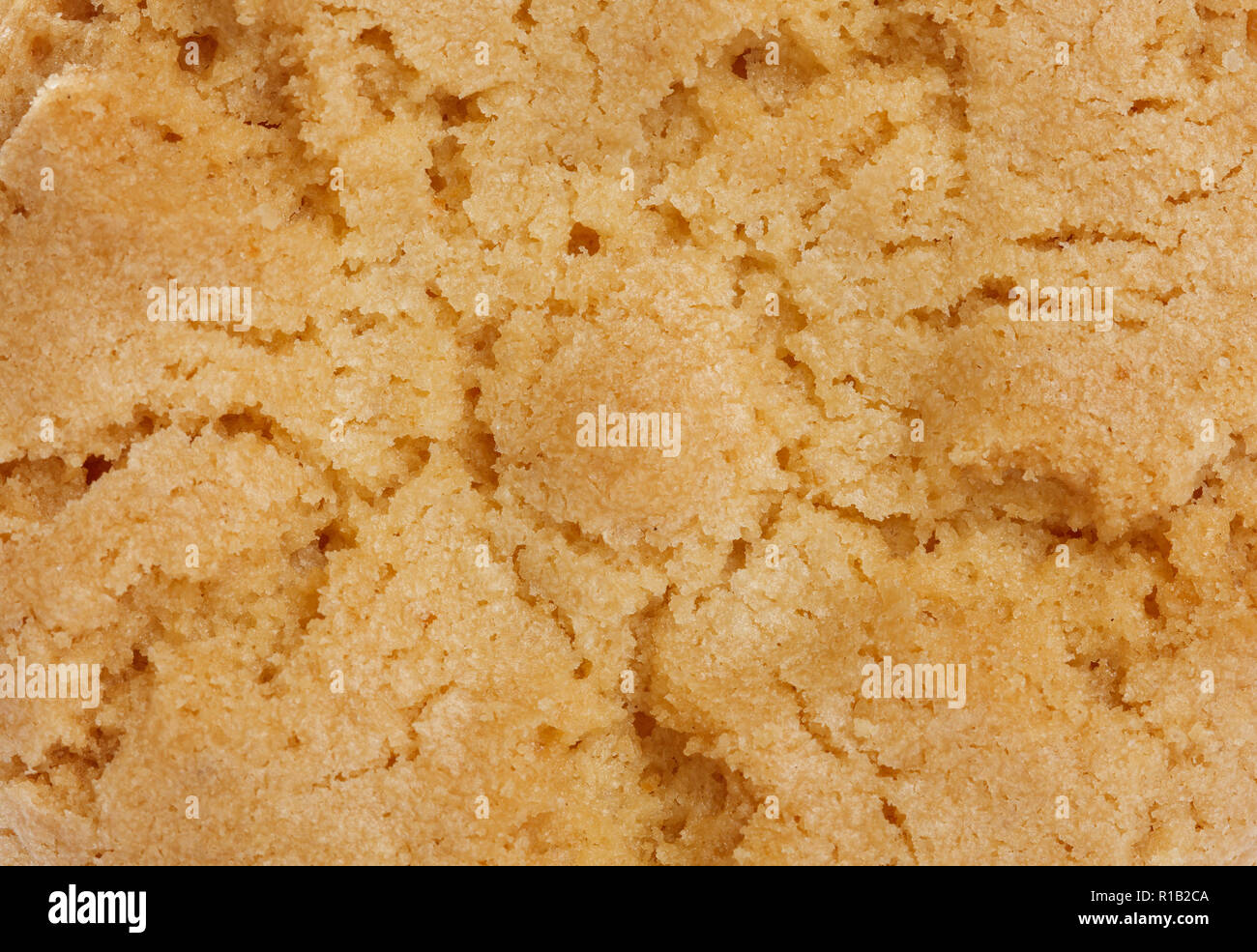 Yellow crunchy cookie background texture, close up. Stock Photo