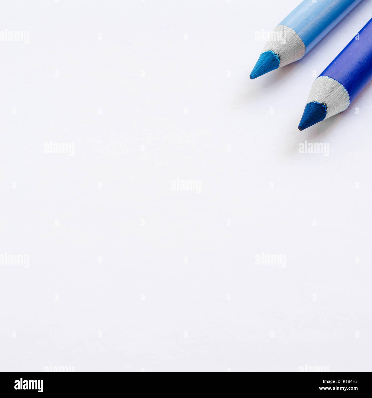 Two blue pencils isolated on white background. Stock Photo