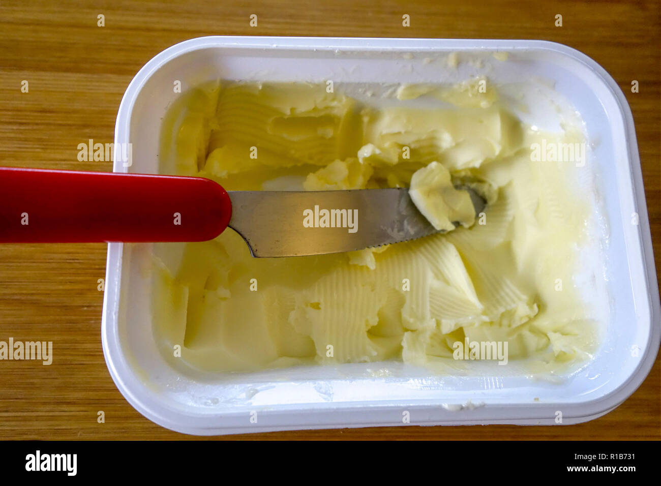 Knife in a carton of Butter Stock Photo