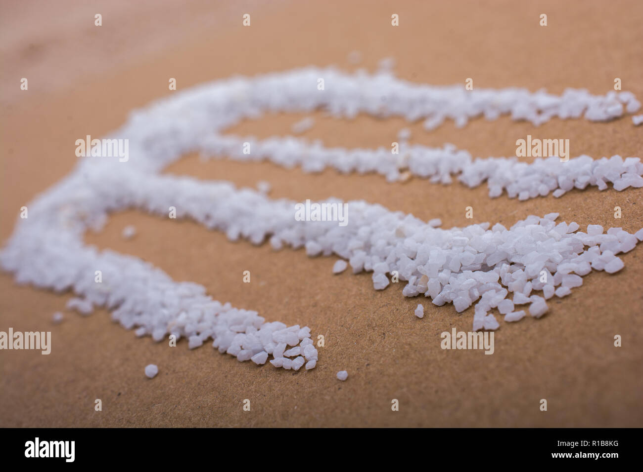 Small white sand scattered on a wooden background Stock Photo