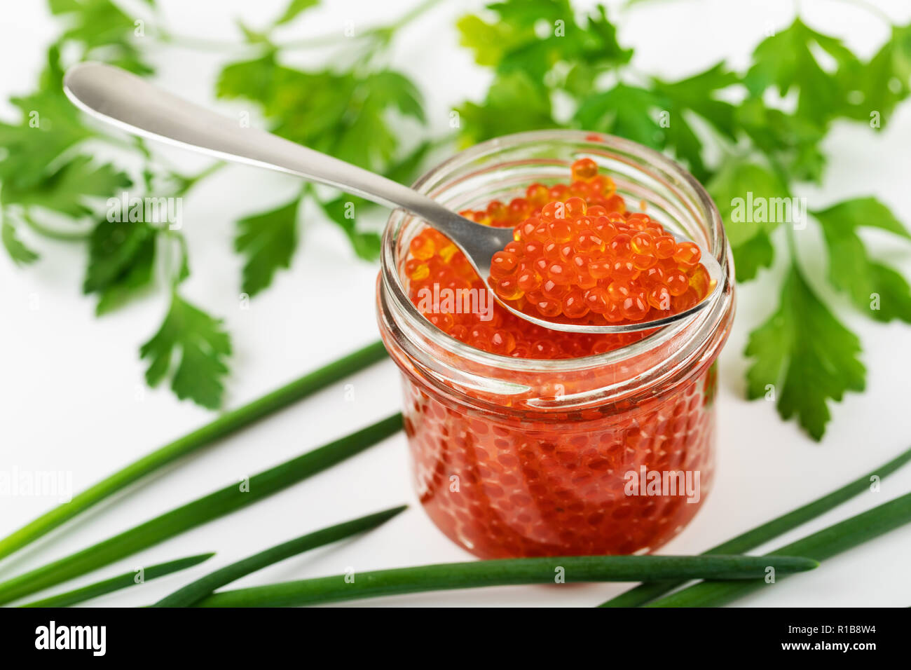 red caviar jar with spoon and herbs Stock Photo