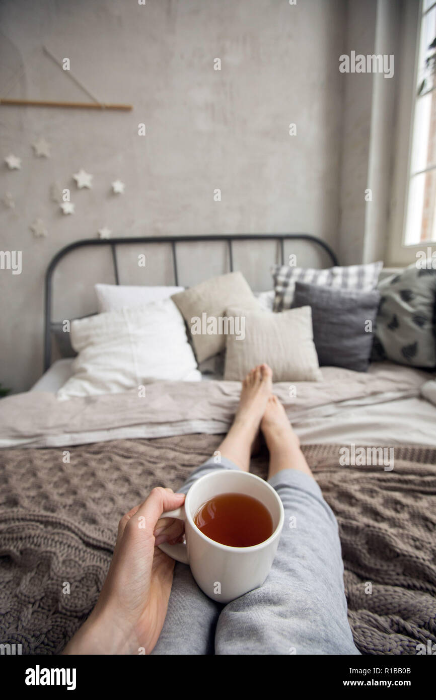 Crop woman having breakfast on bed Stock Photo