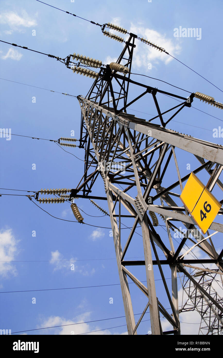 A high voltage power pylons against blue sky and clouds Stock Photo - Alamy
