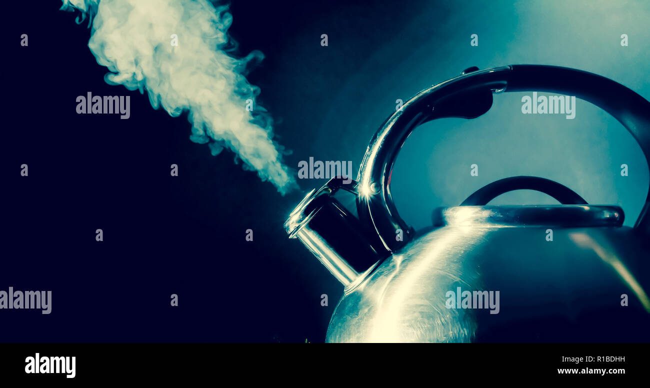 Kettle whistling, boiling kettle, steam, isolated on a black background
