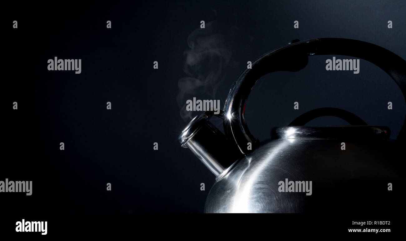 Kettle whistling, boiling kettle, steam, isolated on a black background