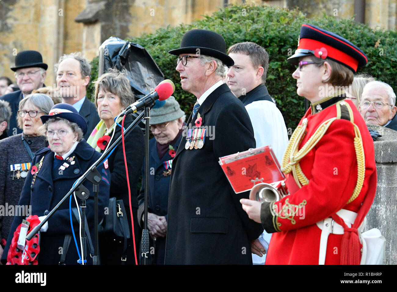 Bridport, Dorset, UK.  11th November 2018.  Master of ceremonies at the Remembrance Sunday service at the war memorial outside St Mary's Church in South Street in Bridport.  The 2018 Remembrance Day falls on the 100th Anniversary of armistice day which marks the ending of World War One.  Picture Credit: Graham Hunt/Alamy Live News Stock Photo