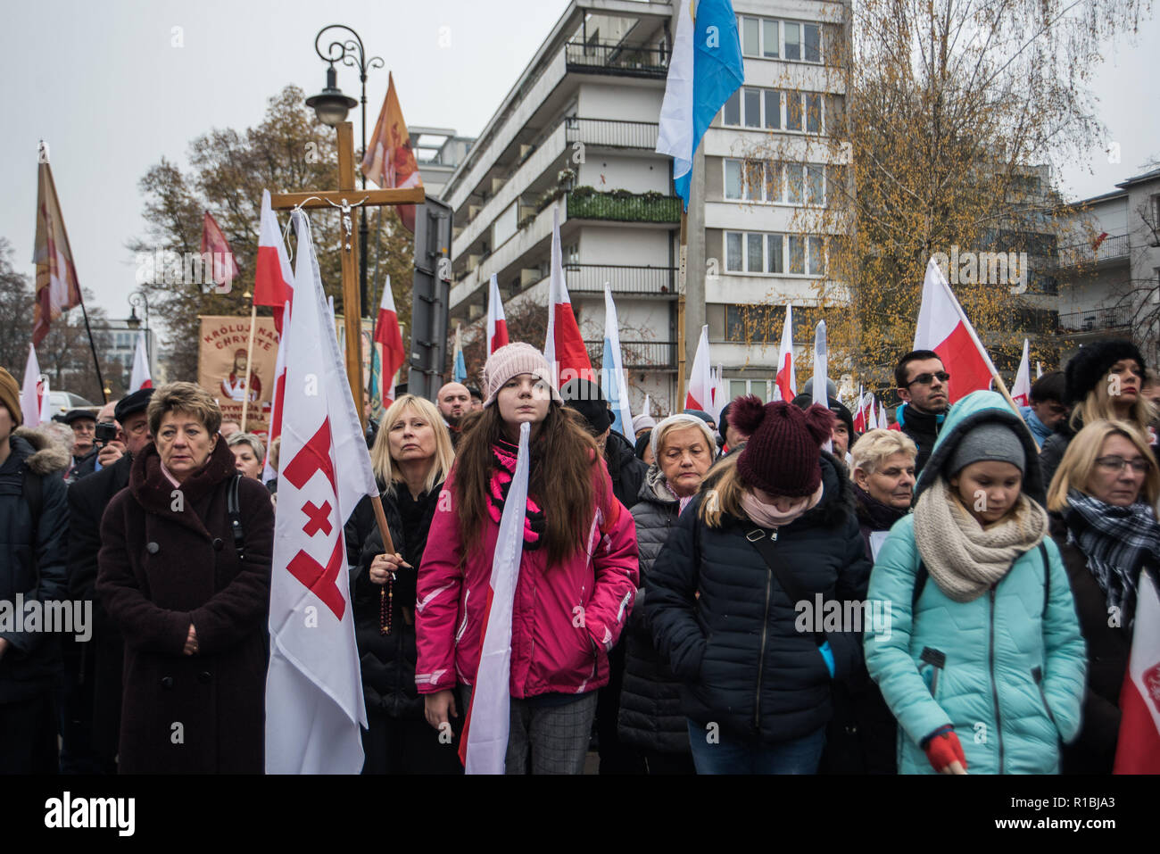 Warsaw, Poland. 11th Nov, 2018. Members of the National Radical Camp (ONR) and the conservative right wing associations are seen holding flags while praying next to the Polish Parliament before the official march.Days before the Independence Day, the mayor of warsaw, Hanna Gronkiewicza banned the Independence Day march organized by the extreme right wing associations while on the same day, the Polish government announced a state march that would depart from the same place as they banned the Independence Day march. Credit: ZUMA Press, Inc./Alamy Live News Stock Photo