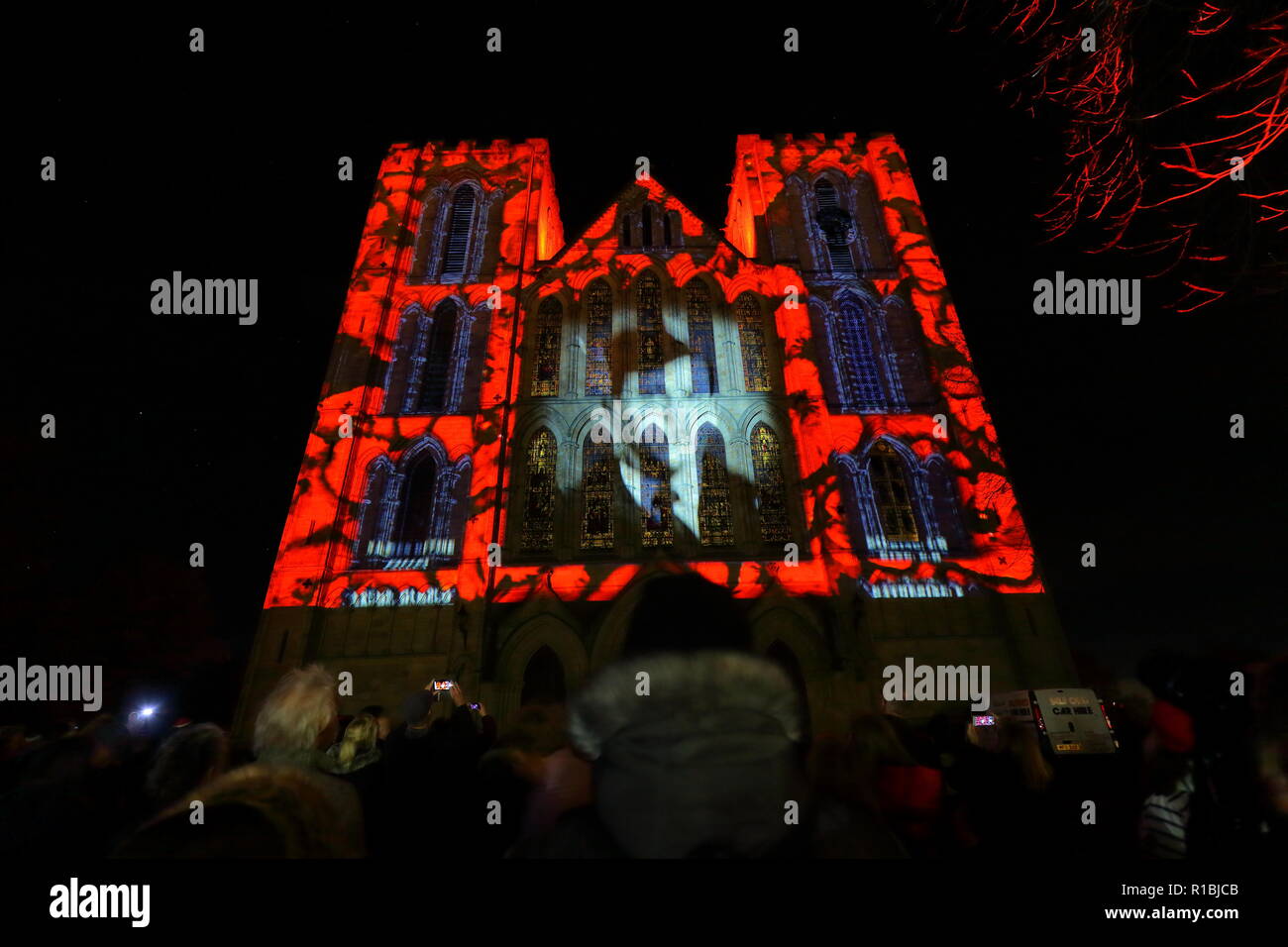 Ripon,North Yorkshire,UK. 10th November 2018. Ripon Cathedral puts on an illuminated projection display to mark armistice day 2018. The display shows still images from the war along with names of some of those who lost their lives. Animated poppies also cascade down the face of the cathedral where 1000's gathered to watch the final showing. Credit: Yorkshire Pics/Alamy Live News Stock Photo