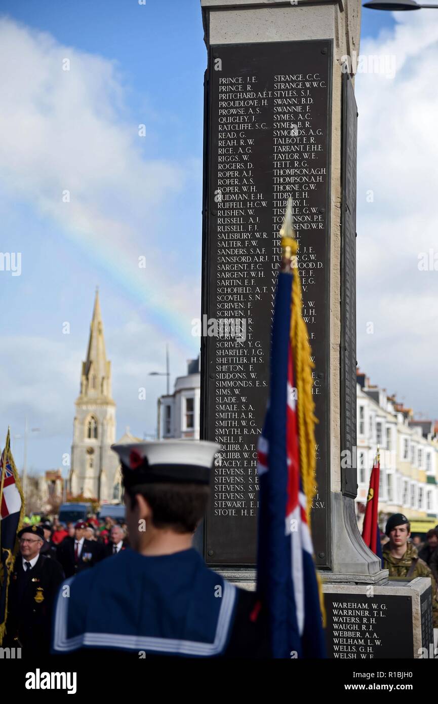 Weymouth, Dorset, UK. 11th Nov, 2018. Remembrance Sunday service and parade in Weymouth, Dorset, UK, Rainbow behind the cenotaph Credit: Finnbarr Webster/Alamy Live News Stock Photo