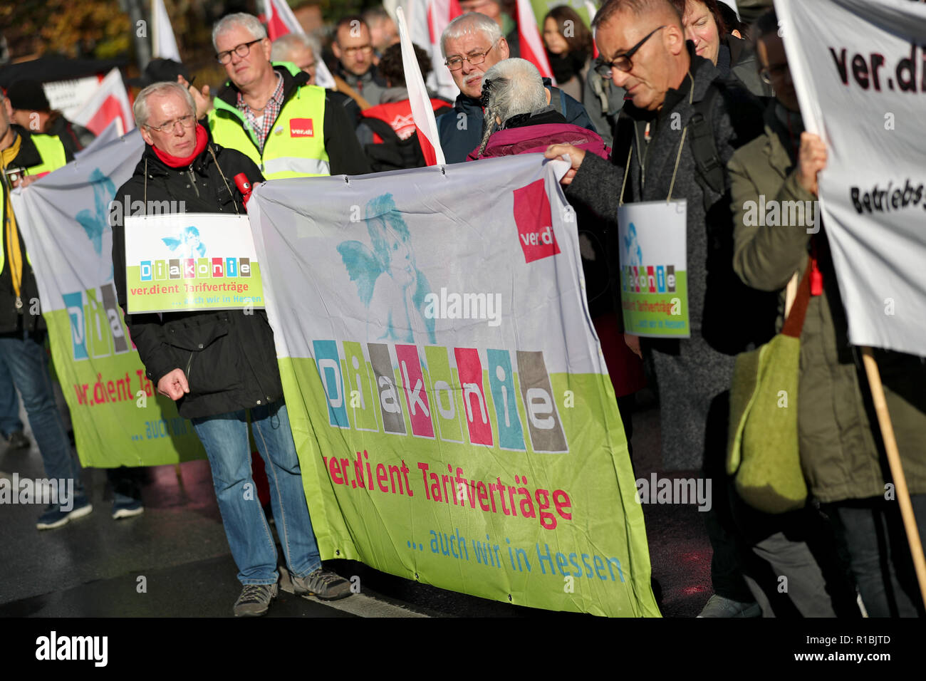 Wurzburg, Bavaria, Germany. 11th Nov, 2018. Staff members of Diakonie and the Protestant Church protested on the fringes of the annual conference of the Synod of the Protestant Church in Germany (EKD). They protested against a draft amendment to the Employee Representation Act of the EKD. Photo: Daniel Karmann/dpa Credit: dpa picture alliance/Alamy Live News Stock Photo