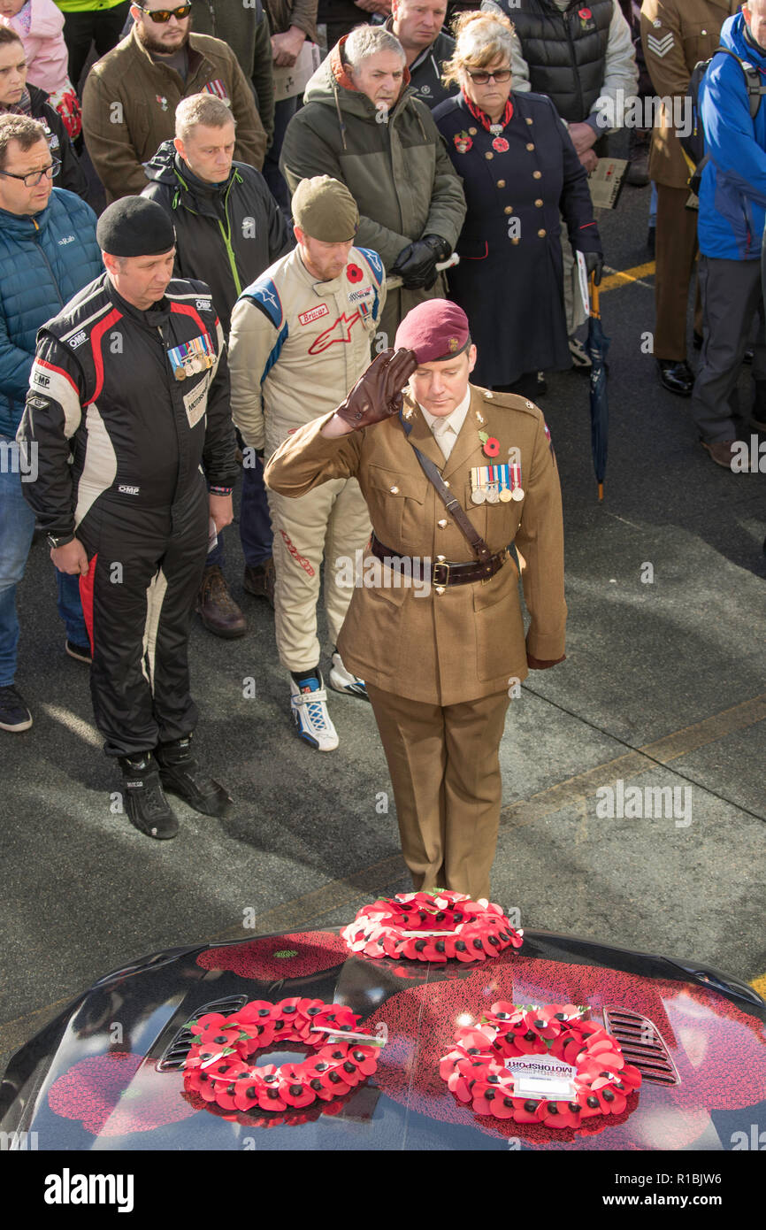 Ty Croes, Anglesey, Wales, UK. 11th Nov, 2018. Remembering the 100th anniversary of the end of WW1 at the 5th Race of Remembrance at the Anglesey Circuit in Wales. Mission Motorsport helpingthe current generation of veterans rehabilitate through motorsport. 50 teams of drivers come to race for 12 hours in a wide range of different cars. Racing is suspended on the 11th hour for a service of remembrance in the pit lane before returning to racing. The service includes a team of veterans from the US and Canadian armed forces Credit James Wadham / Alamy Live News Stock Photo