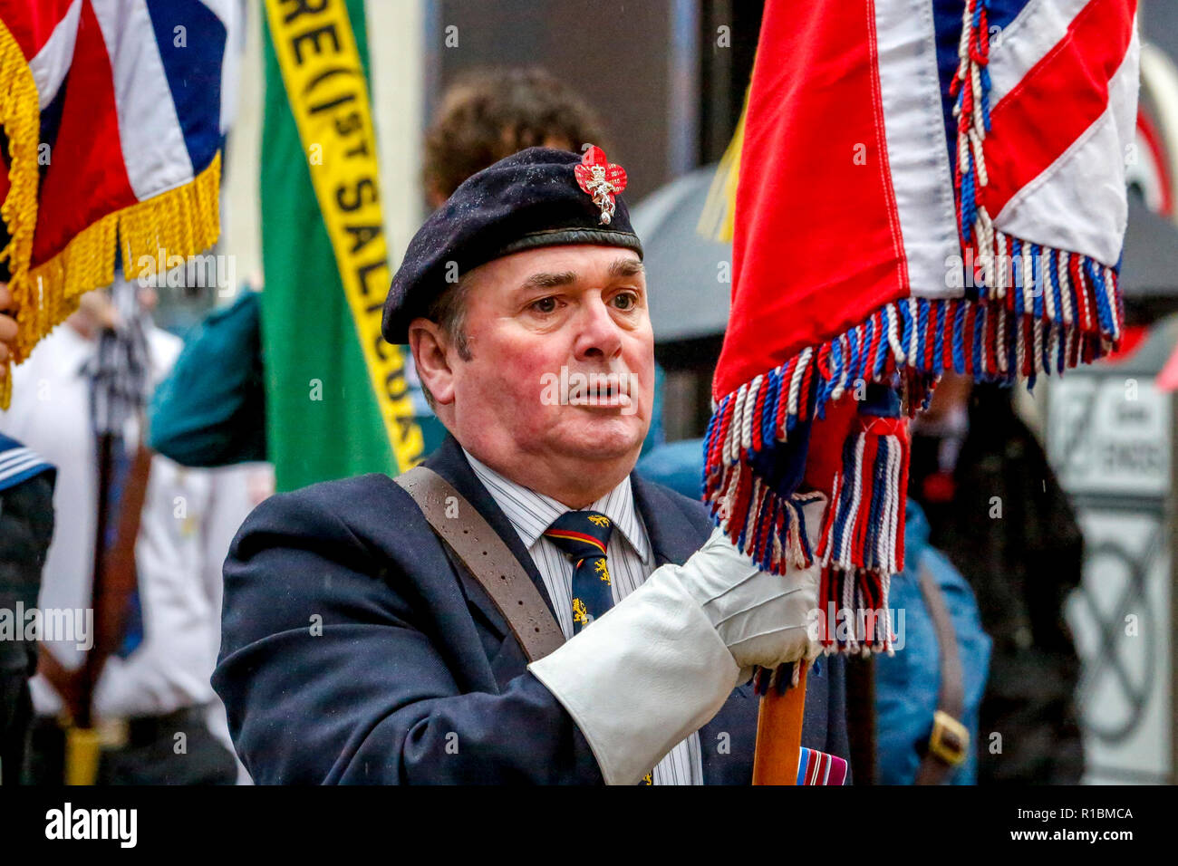 Saltcoats, Ayrshire, UK. 11th Nov, 2018. Heavy rain and strong winds didn't deter over 1000 people turning out at the Cenotaph and war memorial in Saltcoats, Ayrshire, UK to show their respects, lay tributes of wreathes and take part in the Remembrance Day Service commemorating 100 years since the cessation of conflicts in World War 1 Credit: Findlay/Alamy Live News Stock Photo