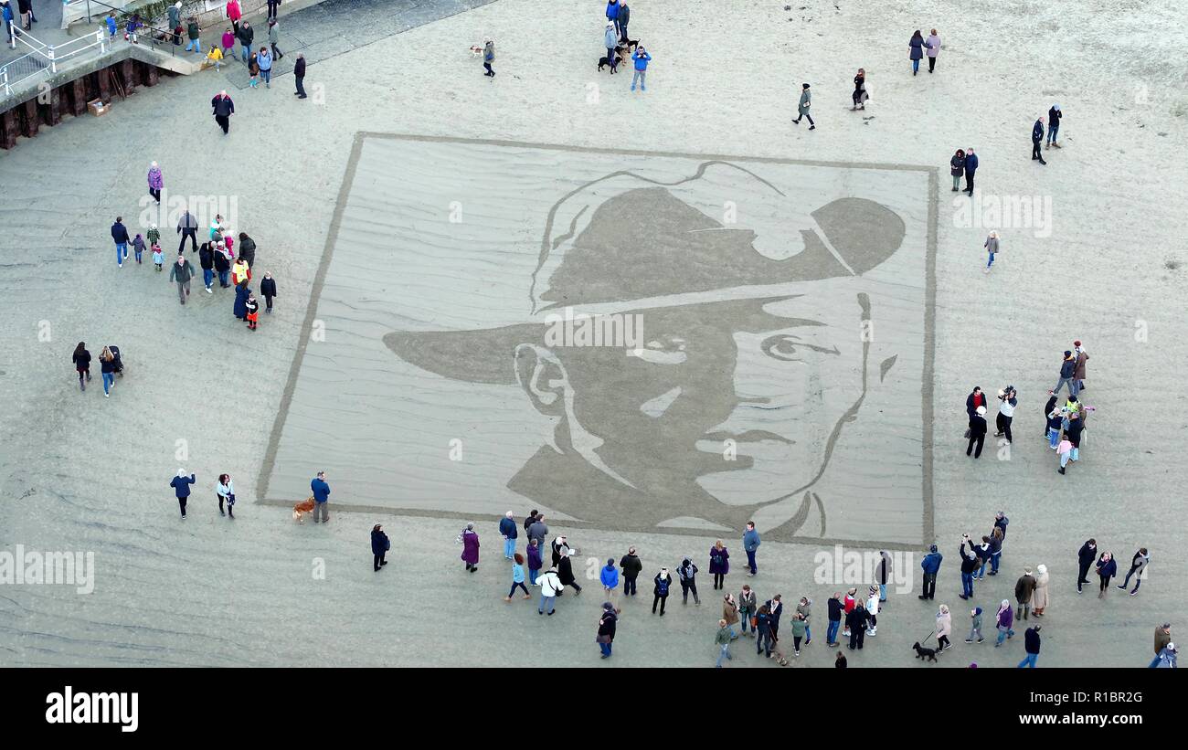 Pages of the Sea. 11th Nov, 2018. The face of Private Stanley McDougall etched onto the shore at Weymouth Beach as part of Pages of the Sea event, Dorset. Picture by Paul Hoskins and Justin Glynn (CAA licenced) Stock Photo