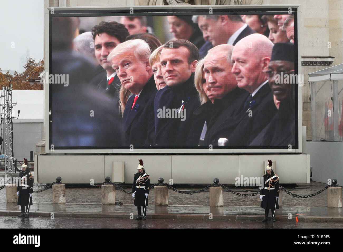 Paris, France. 11th Nov, 2018. A screen in front of the Arc de Triomphe shows the US President Donald Trump, German Chancellor Angela Merkel, French President Emmanuel Macron, Russian President Vladimir Putin and other politicians attend the ceremony to commemorate the 100th anniversary of the end of World War I in Paris, France, Nov. 11, 2018. Credit: Zheng Huansong/Xinhua/Alamy Live News Stock Photo