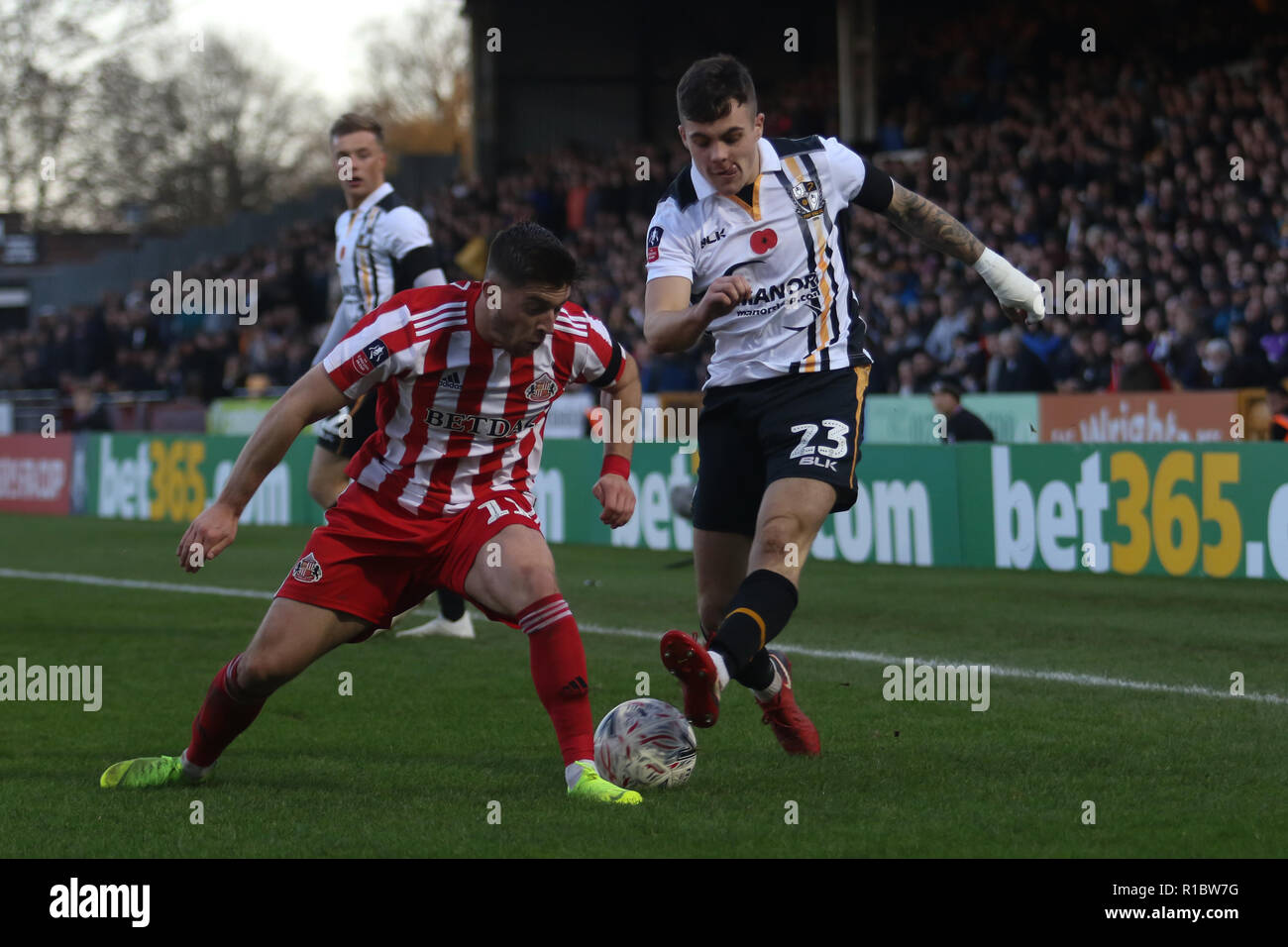 Burslem, Staffordshire, UK. 11th Nov 2018. Port Vale defender Mitchell Clark (23) crosses past Sunderland midfielder Lynden Gooch (11) during the The FA Cup first round match between Port Vale and Sunderland at Vale Park, Burslem, England on 11 November 2018. Photo by Jurek Biegus.  Editorial use only, license required for commercial use. No use in betting, games or a single club/league/player publications. Credit: UK Sports Pics Ltd/Alamy Live News Stock Photo