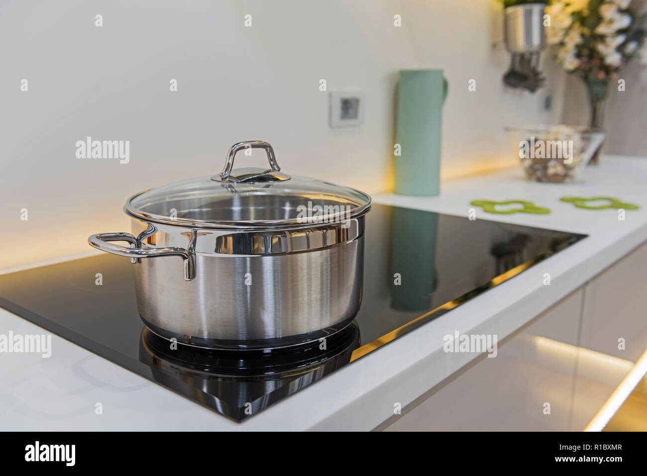 Interior design decor showing modern kitchen with saucepan on cooker