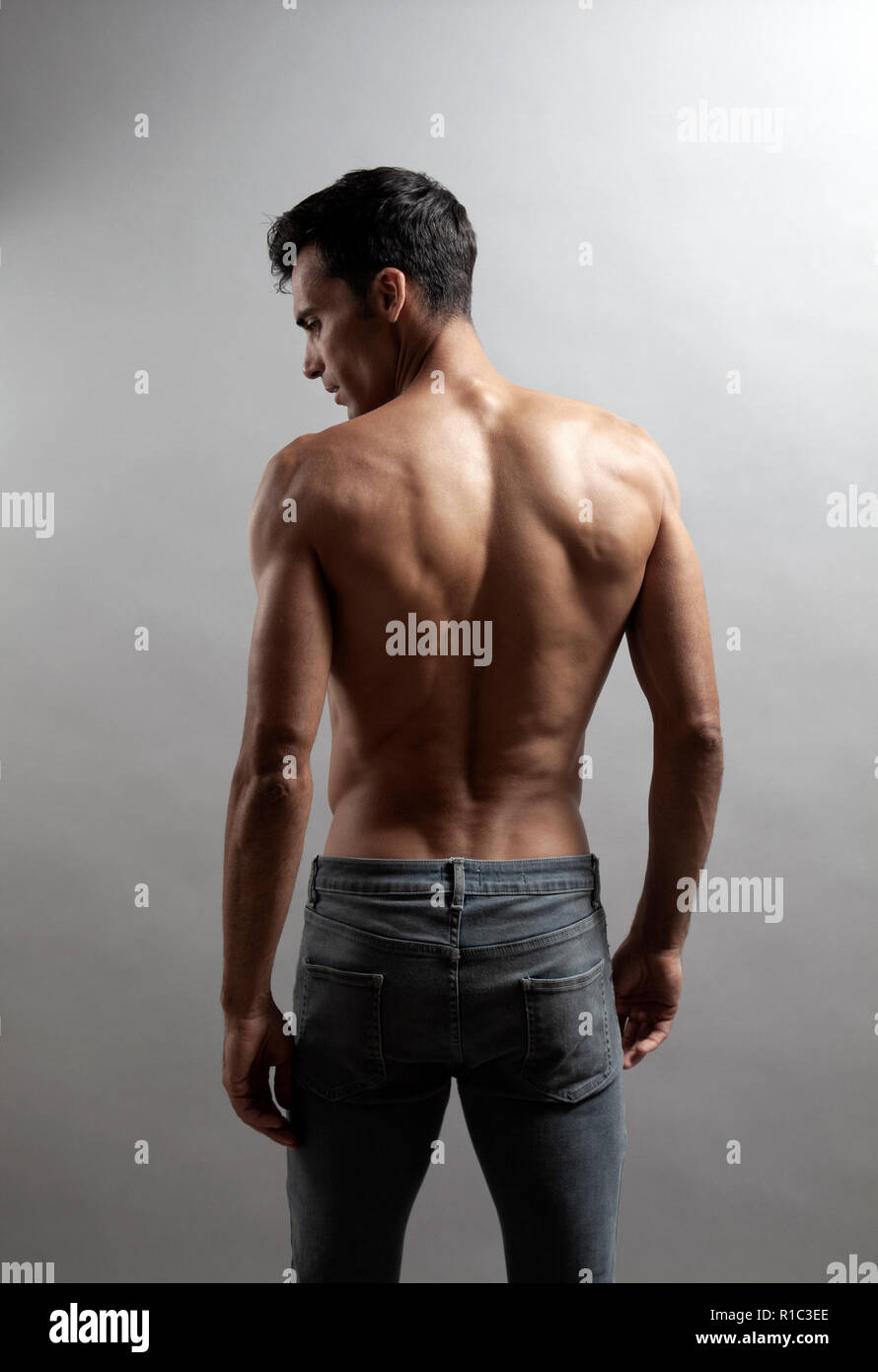 Topless Muscular Man Back in Jeans Stock Photo