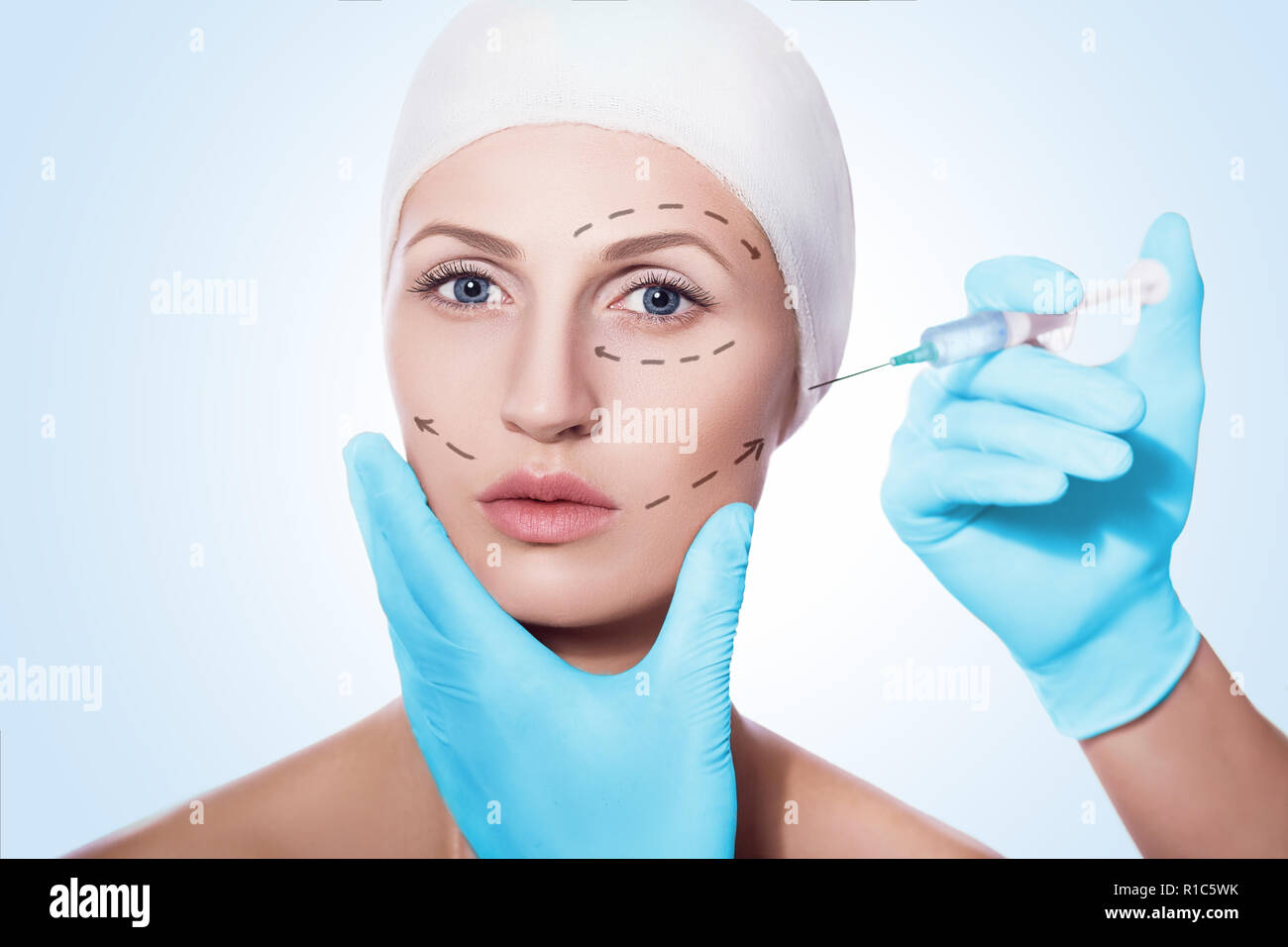 beautiful woman with arrows on face having facial injections Stock Photo