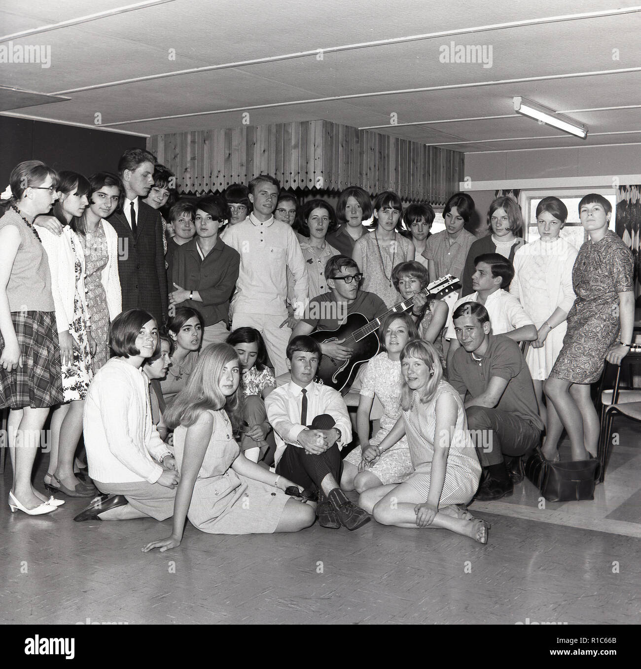 1967, historical, a group of primary school teache gathered together in a room for a leaving party for one of the staff. Stock Photo