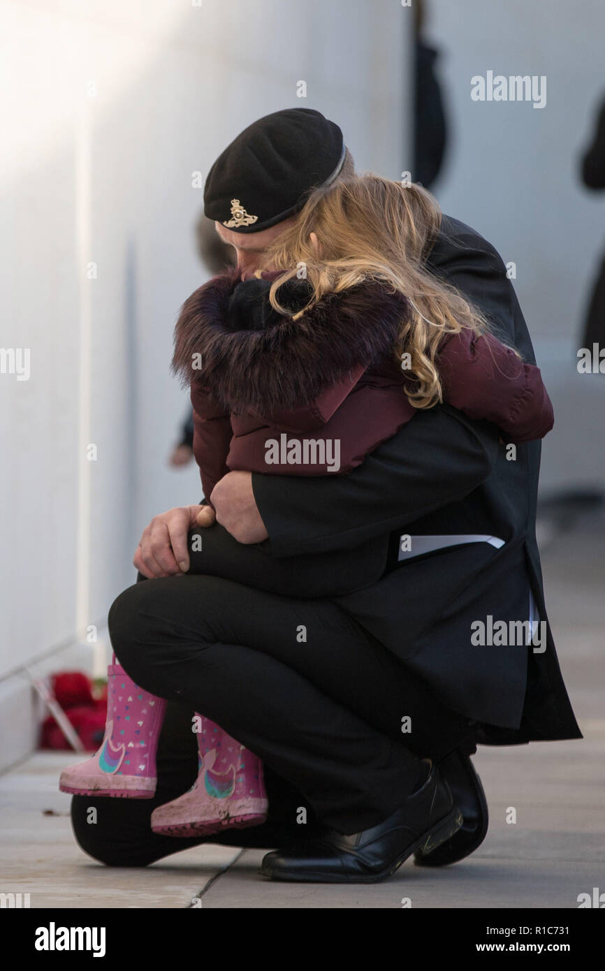 A veteran comforts a girl at the National Memorial Arboretum, Alrewas, Staffordshire, on the 100th anniversary of the signing of the Armistice which marked the end of the First World War. Stock Photo