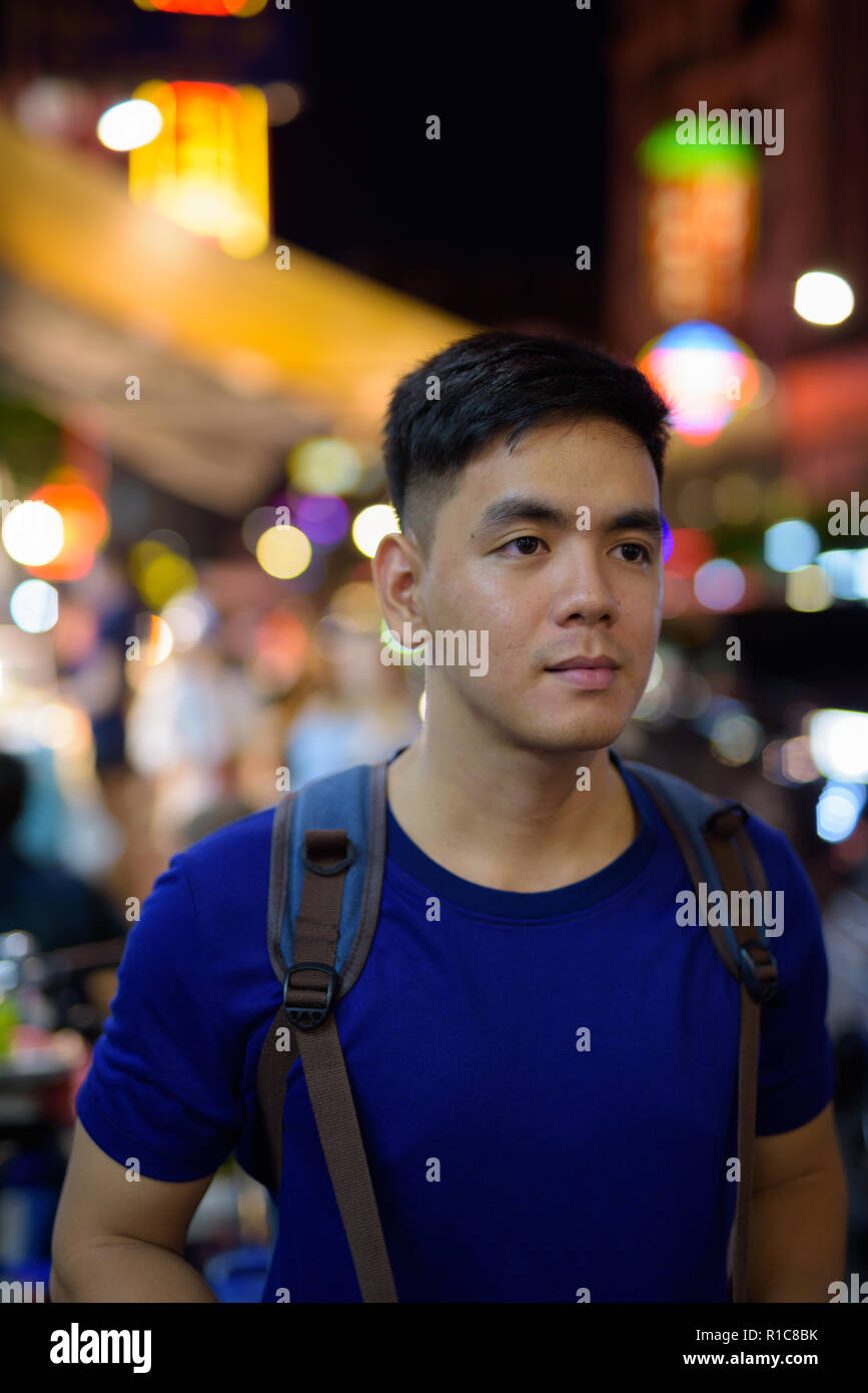 Young Asian tourist man exploring at Chinatown in Bangkok Thailand Stock Photo