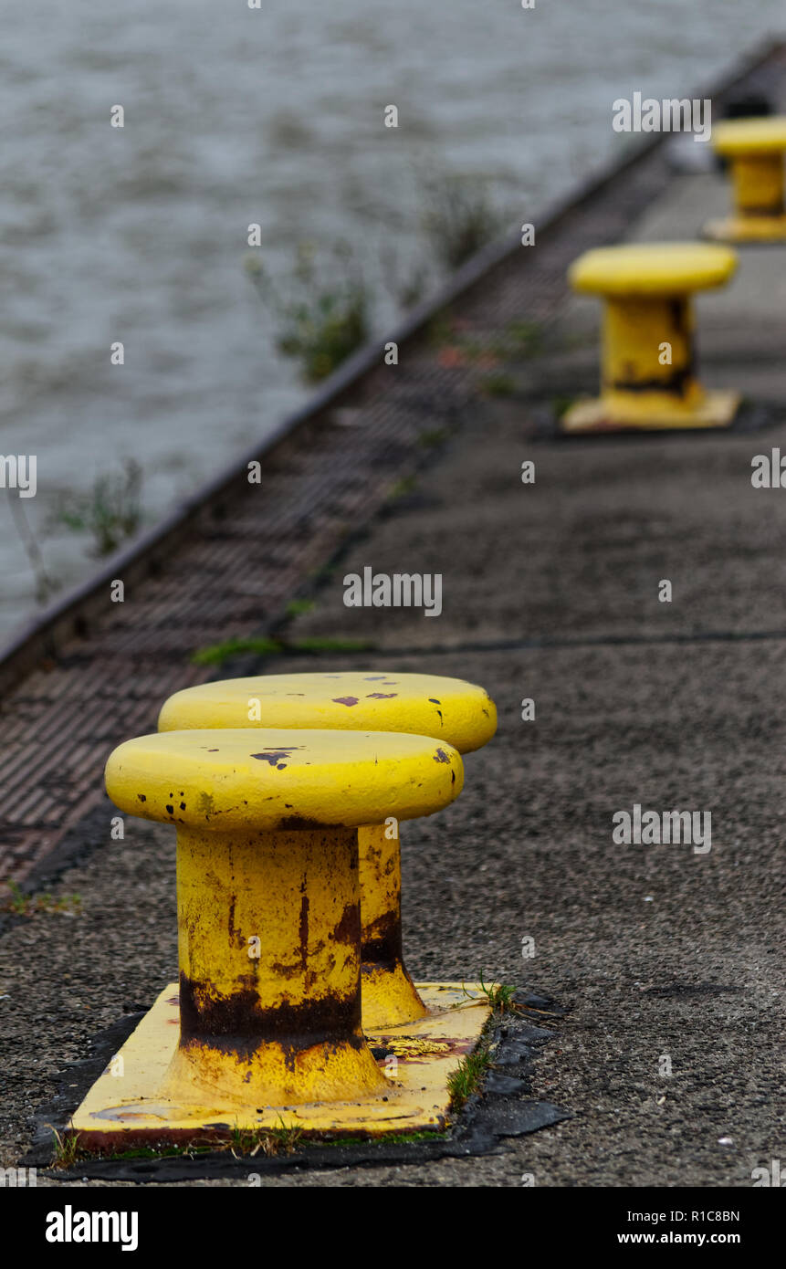Yellow bollards on the quay. Hamburg Blankenese, Germany Stock Photo