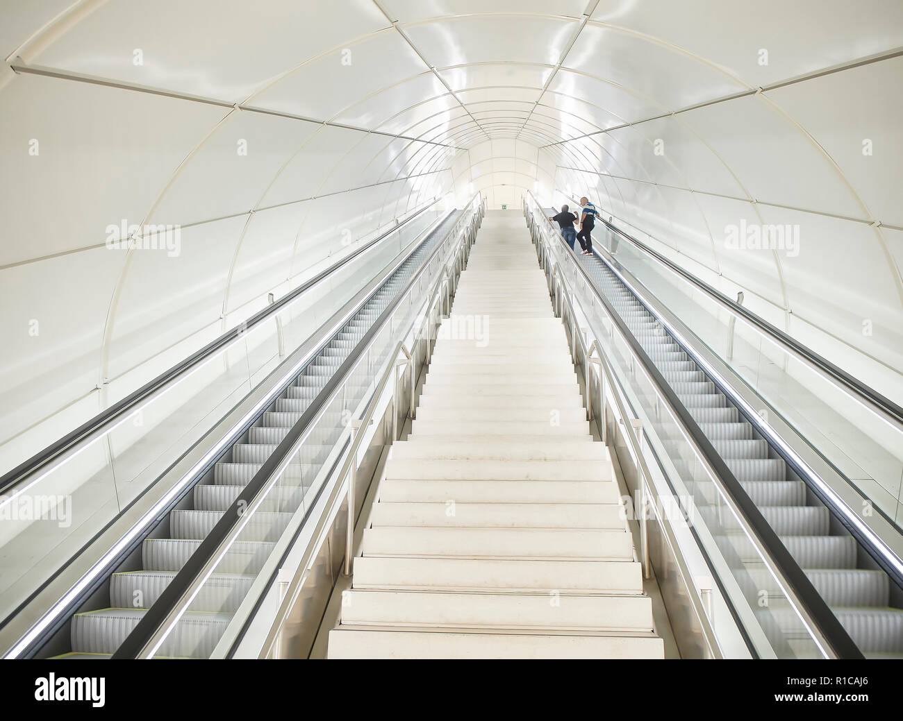 Two men on escalators at a modern underground Metro station Stock Photo ...