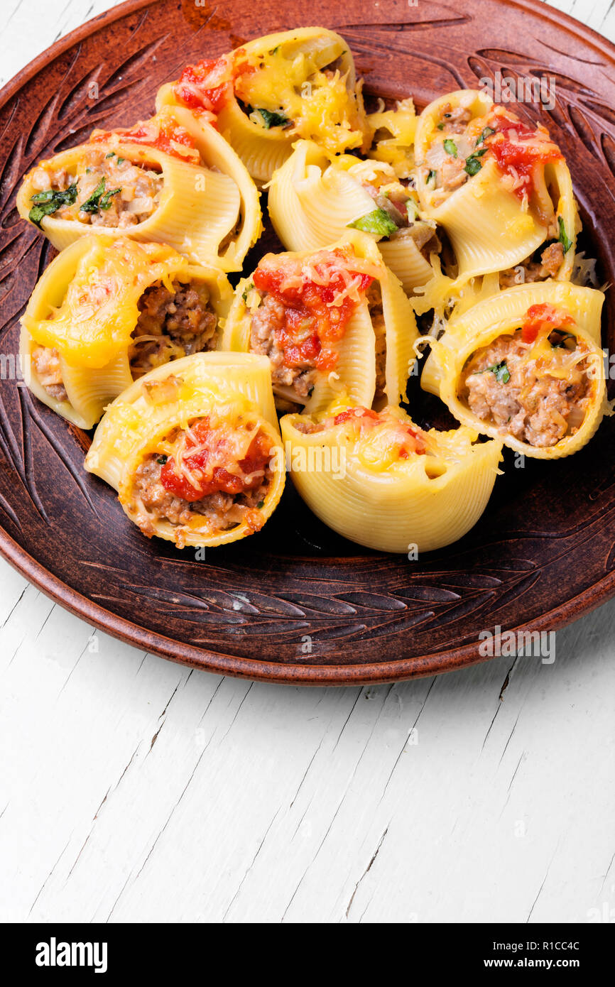 Italian style stuffed pasta shells with meat on a white background ...