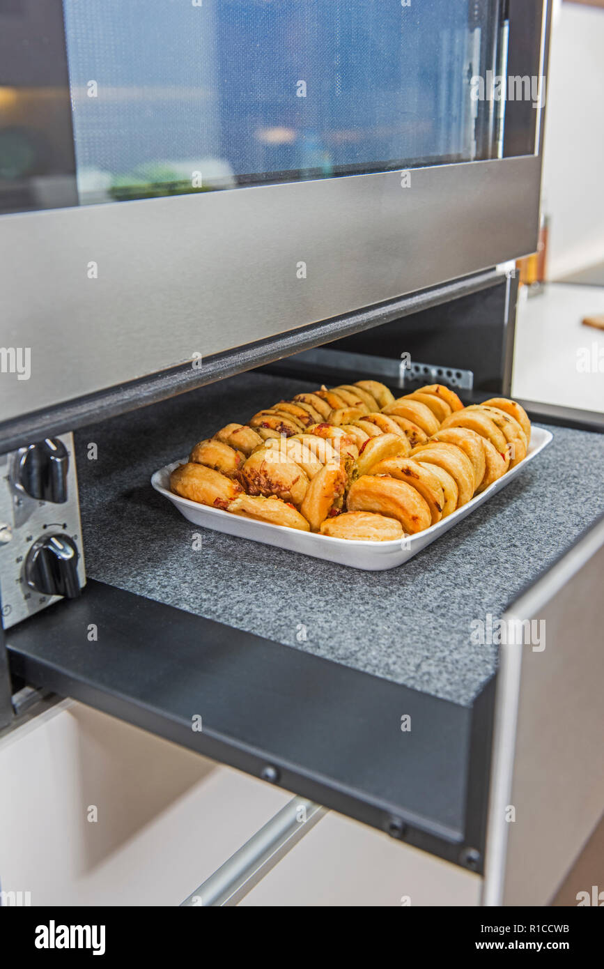 Interior design decor showing modern kitchen with oven warming tray appliance in luxury apartment showroom Stock Photo