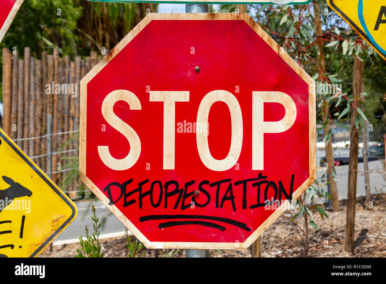 Road traffic sign adapted with environmentally friendly message ('STOP' sign says 'STOP DEFORESTATION', San Diego Zoo Safari Park, Escondido, CA, USA. Stock Photo
