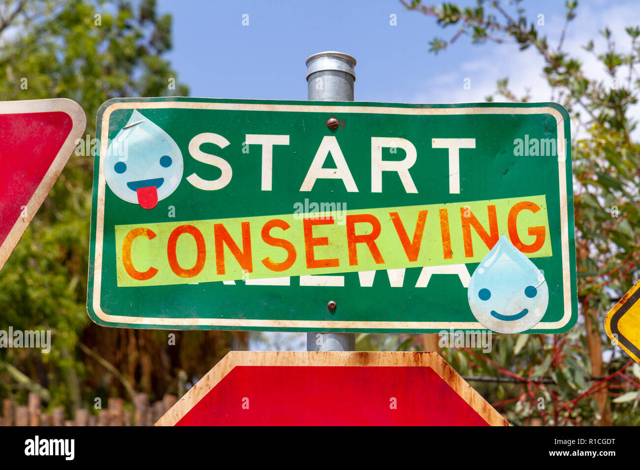 Road traffic sign adapted with environmentally friendly message, San Diego Zoo Safari Park, Escondido, CA, United States, Stock Photo