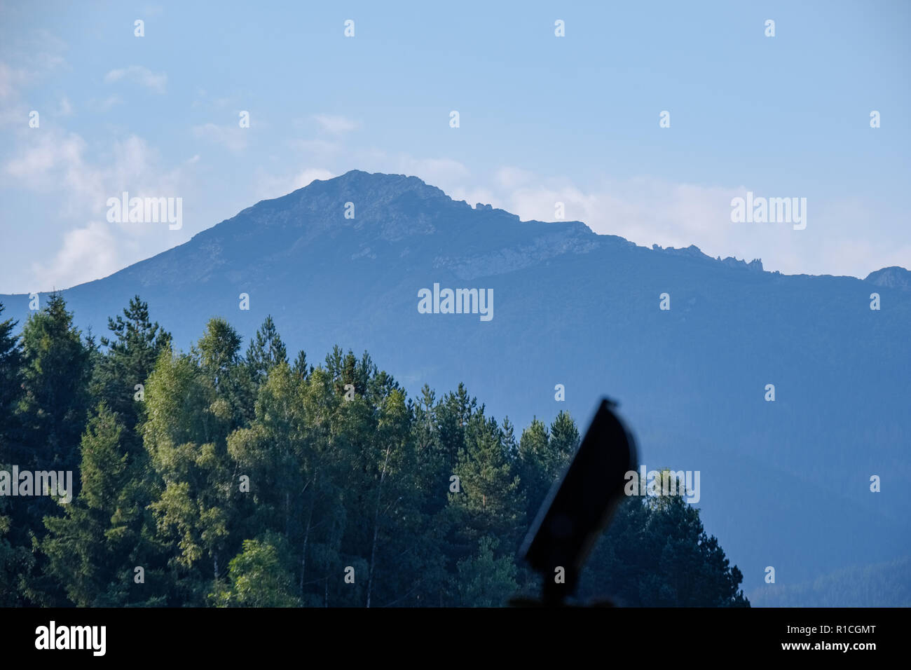 western carpathian mountain tops in autumn covered in mist or clouds ...