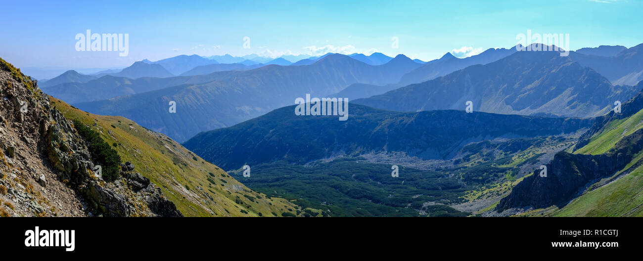 western carpathian mountain tops in autumn covered in mist or clouds ...