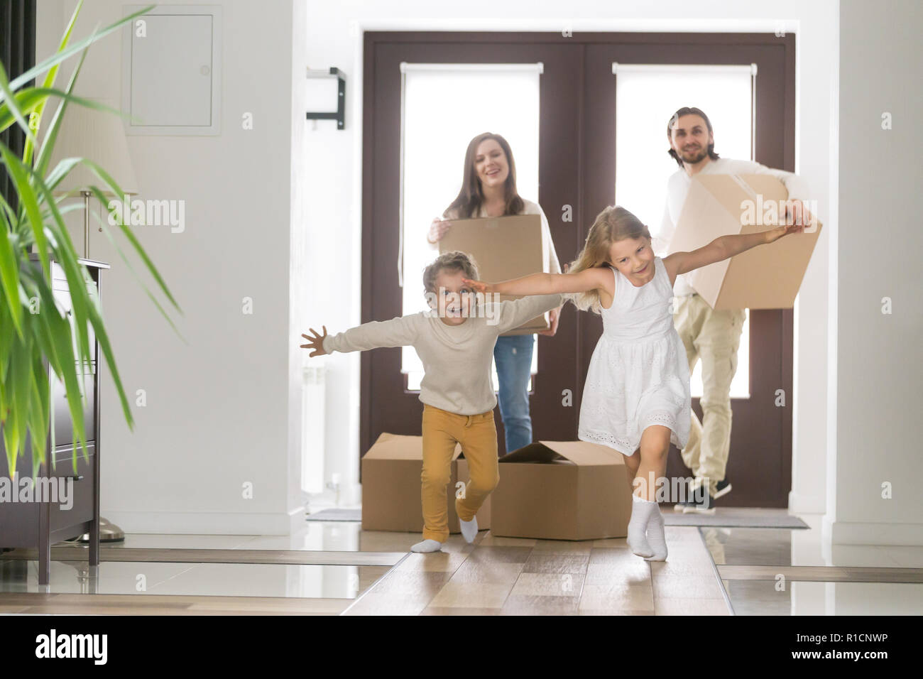 Happy family with children arrived at their new house Stock Photo - Alamy