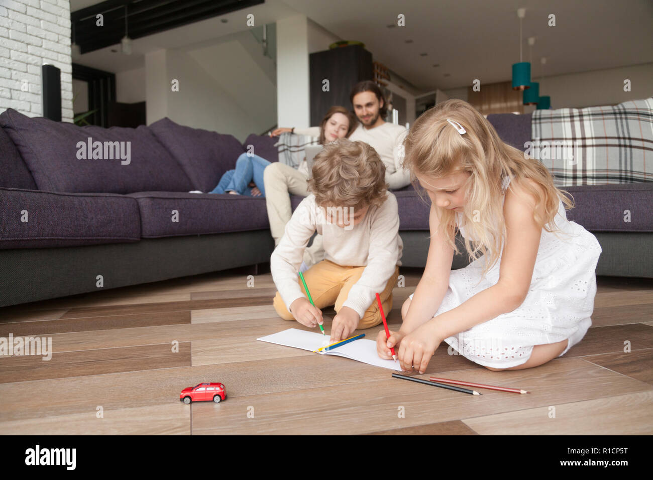 Happy young family with children spending free time at home Stock Photo