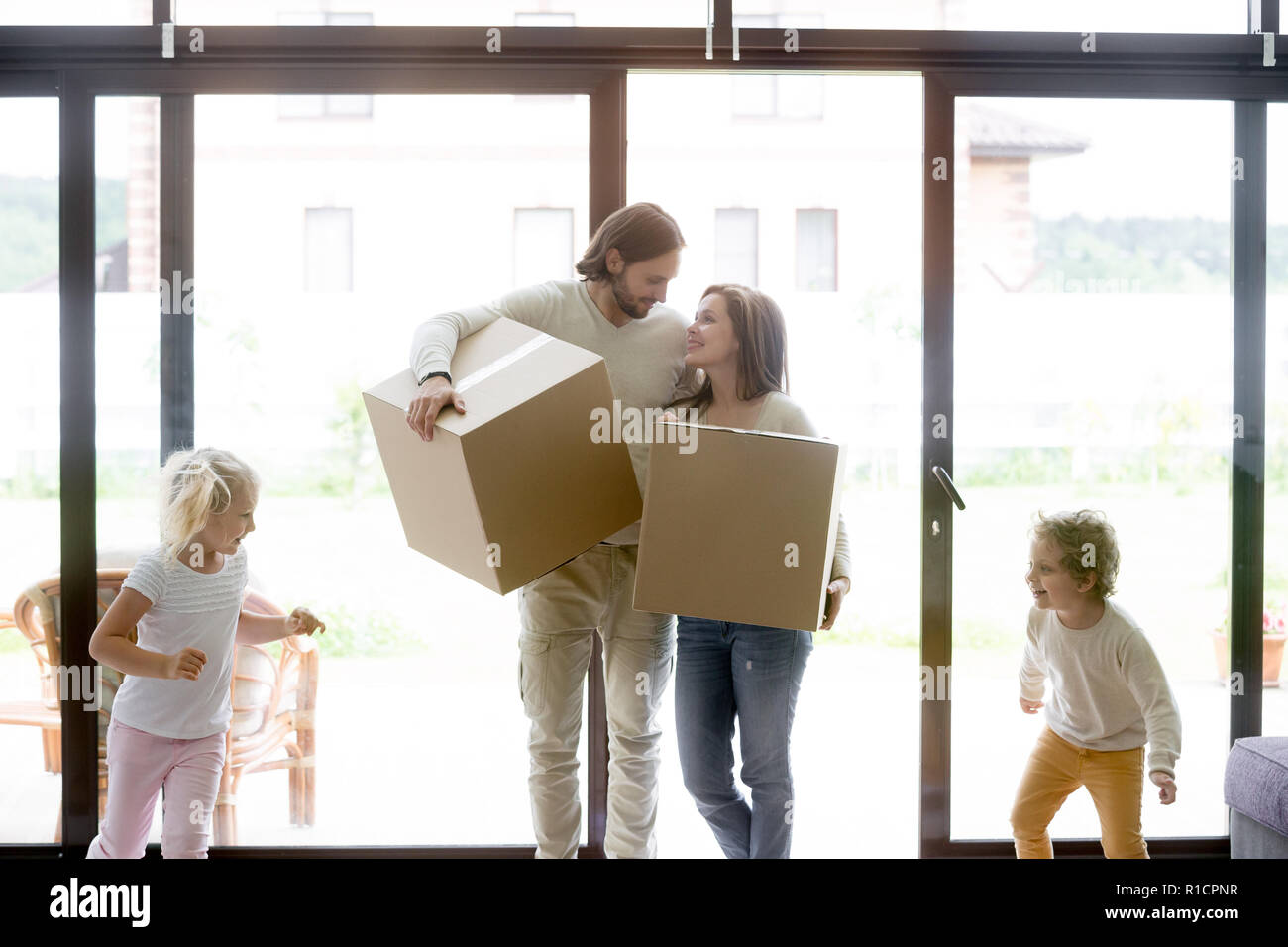 Young whole family moving at new house Stock Photo