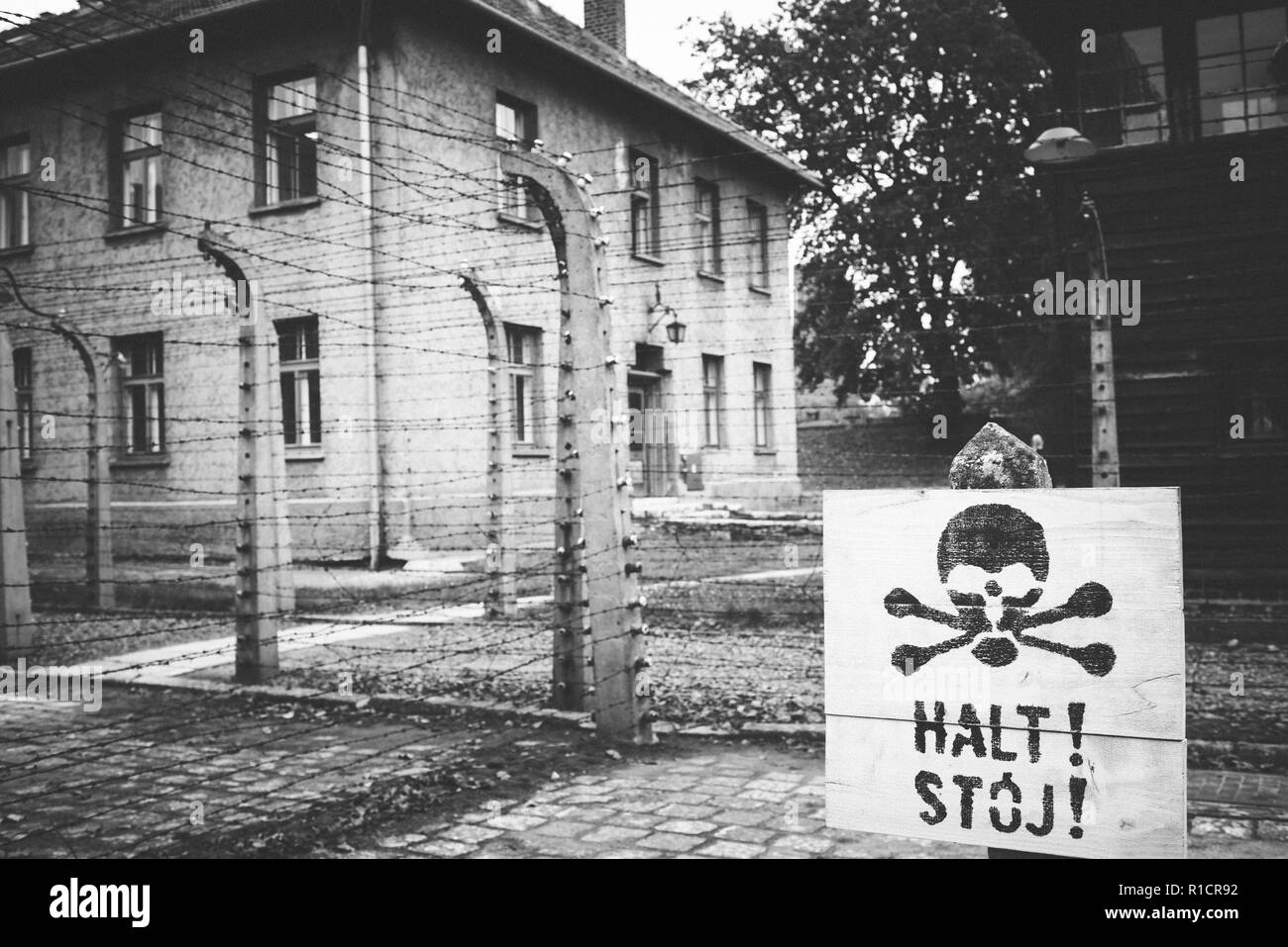 Auschwitz Nazi concentration and extermination camp. Warning sign next to the electrified fence. Auschwitz, German-occupied, Poland, Europe Stock Photo