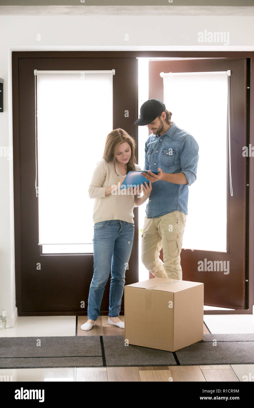 Delivery man brings a package to the customer woman Stock Photo