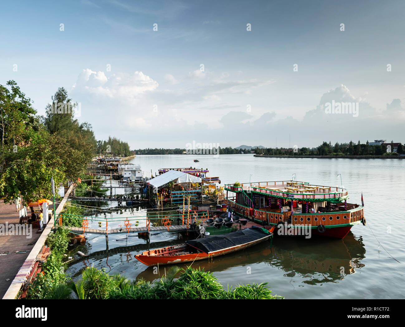Kompot View tourist restaurant boats and landscape at riverside in central kampot ...