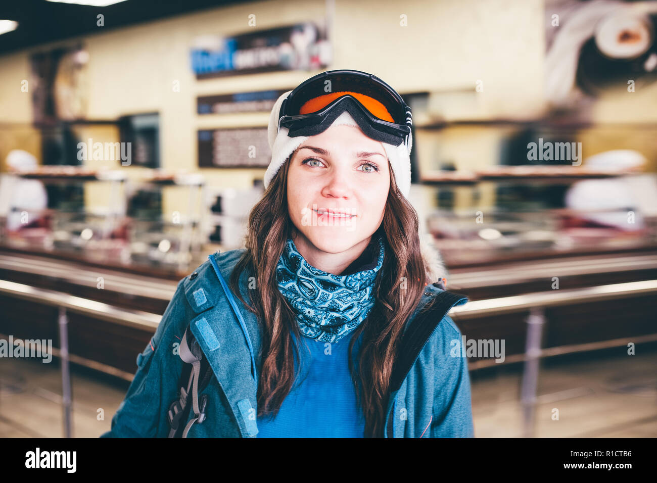 Happy girl on ski resort. Snowboarder on vacation. Lifestyle Concept Adventure winter physical activities. Stock Photo